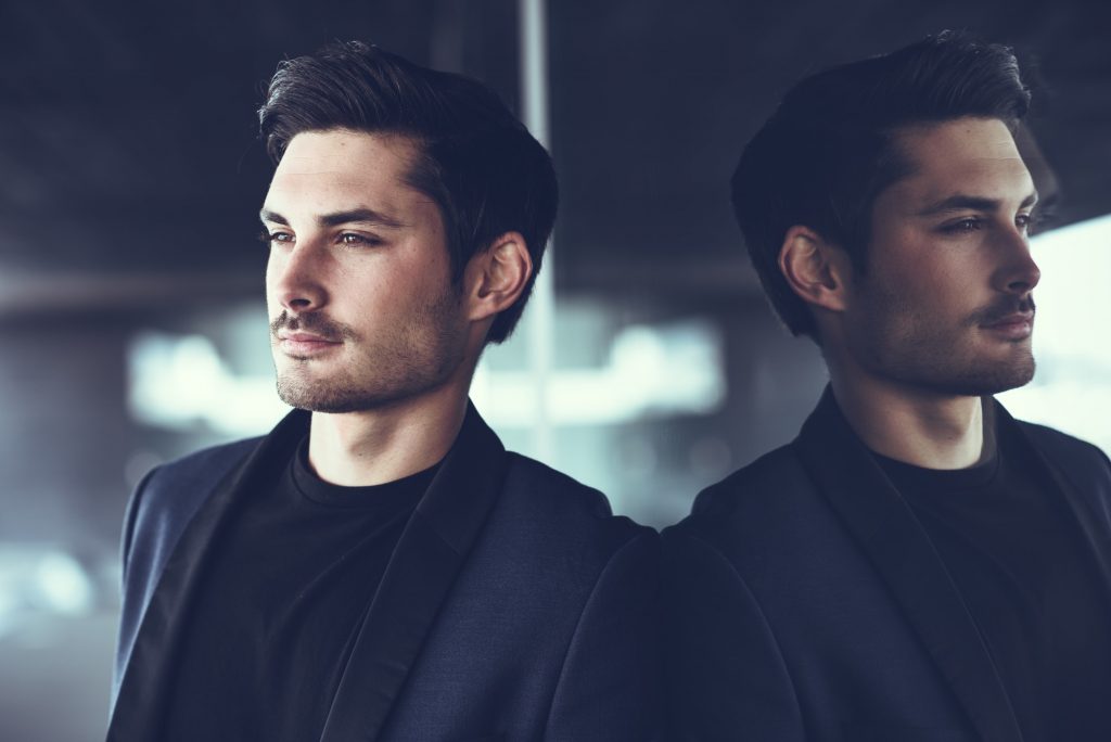 Handsome man, model of fashion, wearing modern suit.